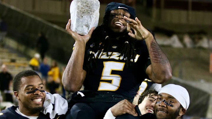 Nov 15, 2025; Columbia, Missouri, USA; Linebackers Josiah Trotter and Jeremiah Beasley carry senior linebacker Khalil Jacobs off the field after taking his rock.