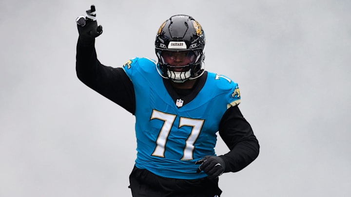 Jacksonville Jaguars offensive tackle Anton Harrison (77) runs on the field before an NFL football matchup at EverBank Stadium, Sunday, Jan. 4, 2026, in Jacksonville, Fla. The Jaguars defeated the Titans 41-7, capturing the AFC South title. [Corey Perrine/Florida Times-Union]