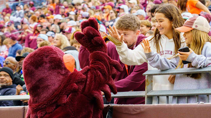 Nov 22, 2025; Blacksburg, Va.; Virginia Tech mascot HokieBird celebrating with fans during the fourth quarter.