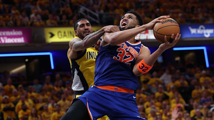 May 27, 2025; Indianapolis, Indiana, USA; New York Knicks center Karl-Anthony Towns (32) drives to the hoop past Indiana Pacers forward Obi Toppin (1) during the third quarter of game four of the eastern conference finals for the 2025 NBA Playoffs at Gainbridge Fieldhouse. Mandatory Credit: Trevor Ruszkowski-Imagn Images
