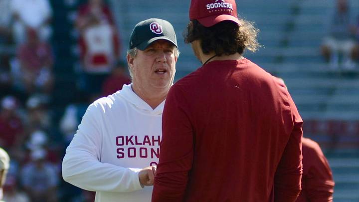 Oklahoma offensive line coach Bill Bedenbaugh talks to defensive ends coach Miguel Chavis before the Sooners' game against South Carolina. Oklahoma offensive line coach Bill Bedenbaugh talks to defensive ends coach Miguel Chavis before the Sooners' game against South Carolina.