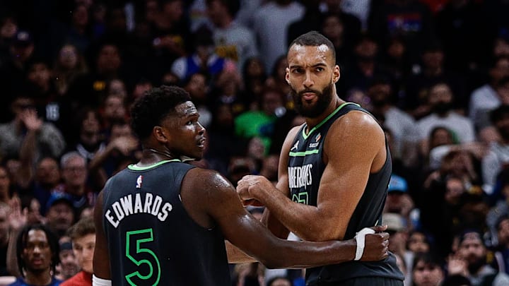 Apr 1, 2025; Denver, Colorado, USA; Minnesota Timberwolves center Rudy Gobert (27) reacts after fouling out as guard Anthony Edwards (5) looks on in the fourth quarter against the Denver Nuggets at Ball Arena. Mandatory Credit: Isaiah J. Downing-Imagn Images