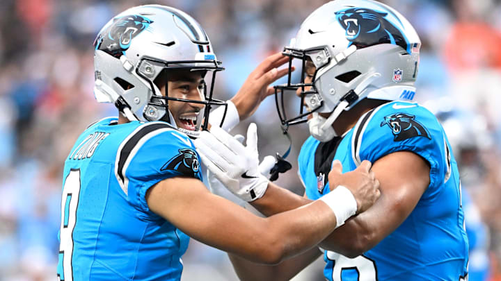 Aug 8, 2025; Charlotte, North Carolina, USA; Carolina Panthers wide receiver Jalen Coker (18) celebrates with quarterback Bryce Young (9) after a touchdown catch in the first quarter at Bank of America Stadium. 