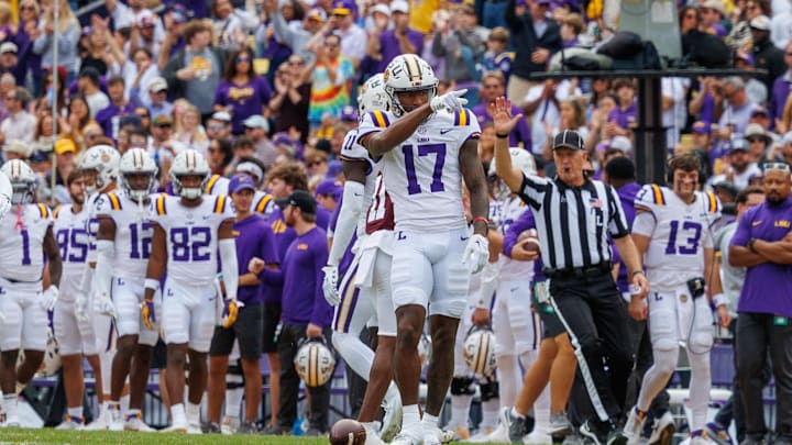 Nov 25, 2023; Baton Rouge, Louisiana, USA;  LSU Tigers wide receiver Chris Hilton Jr. (17) points to the student section after catching a 25 yard pass against Texas A&M Aggies defensive back Deuce Harmon (11) during the second half at Tiger Stadium. Mandatory Credit: Stephen Lew-Imagn Images