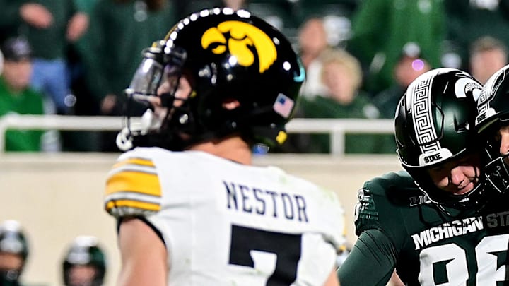 Oct 19, 2024; East Lansing, Michigan, USA;  Michigan State Spartans place kicker Jonathan Kim (97) celebrates with punter Ryan Eckley (96) as Iowa Hawkeyes defensive back John Nestor (7) watches Kim’s sixth field goal go through the uprights at Spartan Stadium. Mandatory Credit: Dale Young-Imagn Images