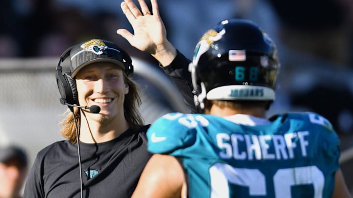 Jacksonville Jaguars quarterback Trevor Lawrence (16) celebrates with Jacksonville Jaguars guard