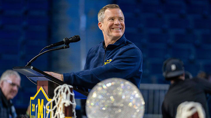 Michigan head coach Dusty May smiles at the podium during a celebration honoring the Wolverines’ NCAA men’s basketball national championship at Crisler Center in Ann Arbor on Saturday, April 11, 2026. Michigan head coach Dusty May smiles at the podium during a celebration honoring the Wolverines’ NCAA men’s basketball national championship at Crisler Center in Ann Arbor on Saturday, April 11, 2026.