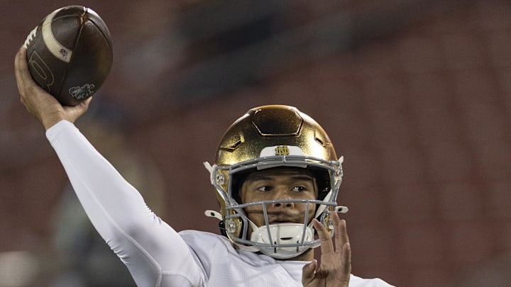 Nov 29, 2025; Stanford, California, USA; Notre Dame Fighting Irish quarterback Kenny Minchey (8) warms up before the start of the first quarter against the Stanford Cardinal at Stanford Stadium. Mandatory Credit: Stan Szeto-Imagn Images Nov 29, 2025; Stanford, California, USA; Notre Dame Fighting Irish quarterback Kenny Minchey (8) warms up before the start of the first quarter against the Stanford Cardinal at Stanford Stadium. Mandatory Credit: Stan Szeto-Imagn Images