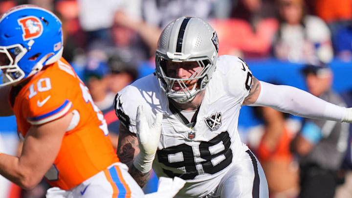 Oct 6, 2024; Denver, Colorado, USA; Las Vegas Raiders defensive end Maxx Crosby (98) chases down Denver Broncos quarterback Bo Nix (10) for a sack in the second half at Empower Field at Mile High. Mandatory Credit: Ron Chenoy-Imagn Images
