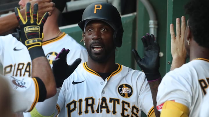 Aug 23, 2025; Pittsburgh, Pennsylvania, USA;  Pittsburgh Pirates designated hitter Andrew McCutchen (22) celebrates his two run home run in the dugout against the Colorado Rockies during the second inning at PNC Park. Mandatory Credit: Charles LeClaire-Imagn Images