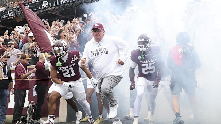 Dec 20, 2025; College Station, TX, USA; Texas A&M Aggies head coach Mike Elko takes the field prior to the game against the Miami Hurricanes during the first round of the CFP National Playoff at Kyle Field. Mandatory Credit: Maria Lysaker-Imagn Images