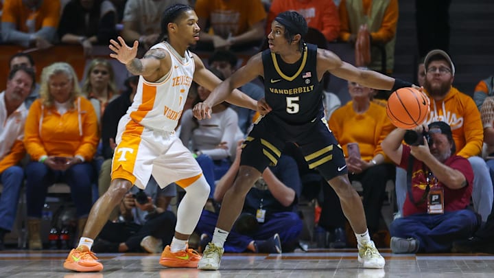 Feb 17, 2024; Knoxville, Tennessee, USA; Vanderbilt Commodores guard Ezra Manjon (5) moves the ball against  Tennessee Volunteers guard Zakai Zeigler (5) during the second half at Thompson-Boling Arena at Food City Center.
