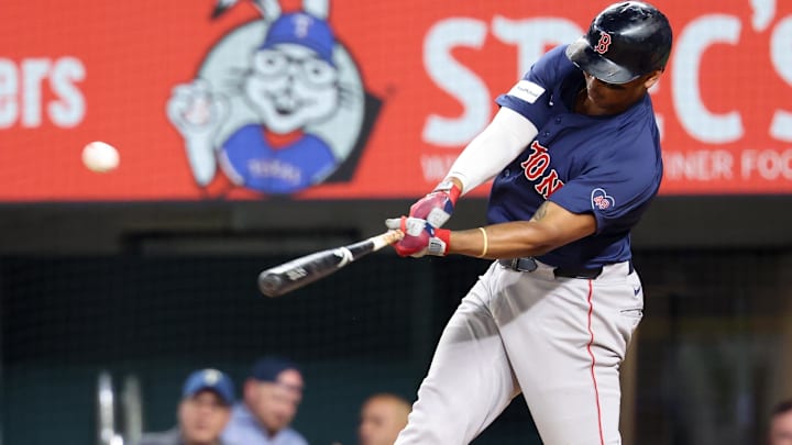 Boston Red Sox third baseman Rafael Devers (11) hits a home run during the ninth inning against the Texas Rangers at Globe Life Field.