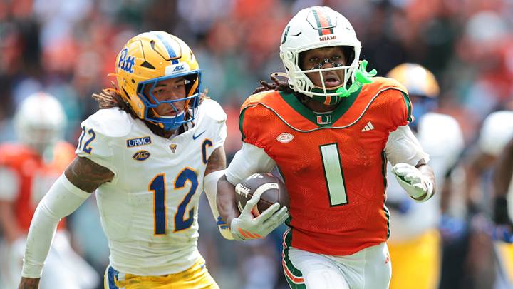 Oct 24, 2026; Miami Gardens, Florida, USA; Miami Hurricanes wide receiver Malachi Toney (1) runs with the football against Pittsburgh Panthers defensive back Cruce Brookins (12) during the second quarter at Hard Rock Stadium. Mandatory Credit: Sam Navarro-Imagn Images Oct 24, 2026; Miami Gardens, Florida, USA; Miami Hurricanes wide receiver Malachi Toney (1) runs with the football against Pittsburgh Panthers defensive back Cruce Brookins (12) during the second quarter at Hard Rock Stadium. Mandatory Credit: Sam Navarro-Imagn Images