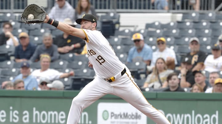 Sep 26, 2024; Pittsburgh, Pennsylvania, USA;  Pittsburgh Pirates first baseman Jared Triolo (19) takes a wide throw to retire Milwaukee Brewers left fielder Sal Frelick (not pictured) during the sixth inning at PNC Park. Mandatory Credit: Charles LeClaire-Imagn Images