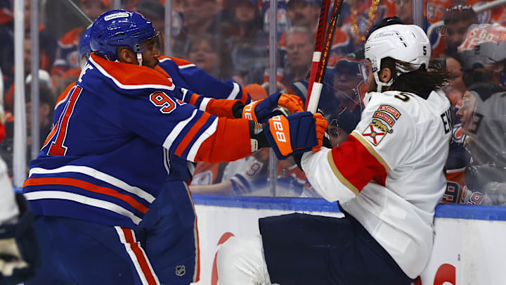 Jun 4, 2025; Edmonton, Alberta, CAN; Edmonton Oilers left wing Evander Kane (91) checks Florida Panthers defenseman Aaron Ekblad (5) during the first period in game one of the 2025 Stanley Cup Final at Rogers Place. Mandatory Credit: Perry Nelson-Imagn Images