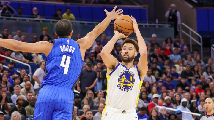 Nov 3, 2022; Orlando, Florida, USA; Golden State Warriors guard Klay Thompson (11) shoots the ball against Orlando Magic guard Jalen Suggs (4) during the first quarter at Amway Center.