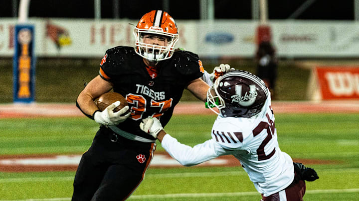 Byron’s Caden Considine (37) pushes off defense during the IHSA 3A football state championship game against Tolono Unity on Nov. 28, 2025, at Illinois State University in Normal.