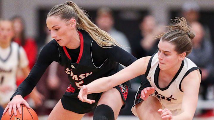 SPASH’s Jada Seubert (5) protects the ball from De Pere High School's Adeline Dwyer (10) during a WIAA Division 1 sectional semifinal on Thursday, March 5, 2026, at Pulaski High School in Pulaski, Wis. SPASH won the game, 67-49.
Tork Mason/USA TODAY NETWORK-Wisconsin