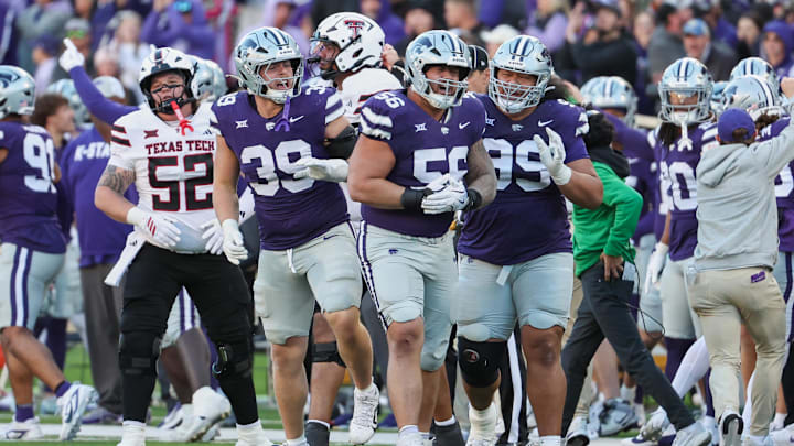 Kansas State defensive tackle Damian Ilalio (56), defensive end Travis Bates (39) and defensive tackle Uso Seumalo (99) celebrate fumble recovery vs. Texas Tech.