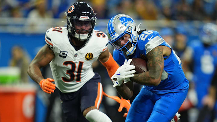 Detroit Lions running back Jahmyr Gibbs (26) runs for yards against Chicago Bears safety Kevin Byard III (31) on Thanksgiving Day at Ford Field in Detroit on Thursday, Nov. 28, 2024.