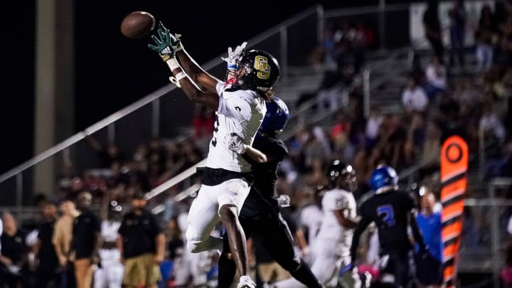 Golden Gate Titans wide receiver Bradley Martino (2) makes a catch over Barron Collier Cougars defensive back Nathan Hendry (8) and scores a touchdown during the third quarter of a district game at Barron Collier High School in Naples on Friday, Oct. 13, 2023.