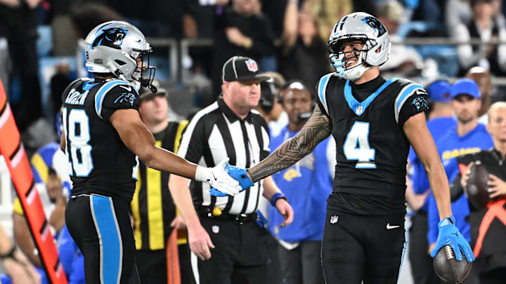 Jan 10, 2026; Charlotte, NC, USA; Carolina Panthers wide receiver Tetairoa McMillan (4) reacts with wide receiver Jalen Coker (18) in the second half during the NFC Wild Card Round game at Bank of America Stadium. Mandatory Credit: Bob Donnan-Imagn Images