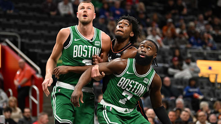 Mar 22, 2024; Detroit, Michigan, USA; Detroit Pistons center James Wiseman (13) center, battles for position on the foul line against Boston Celtics center Kristaps Porzingis (8) (left) and guard Jaylen Brown (7) in the first quarter at Little Caesars Arena. Mandatory Credit: Lon Horwedel-Imagn Images