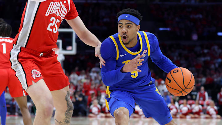 Nov 29, 2024; Columbus, Ohio, USA; Pittsburgh Panthers guard Ishmael Leggett (5) drives to the rim as Ohio State Buckeyes center Austin Parks (25) defends during the first half at Value City Arena. Mandatory Credit: Joseph Maiorana-Imagn Images