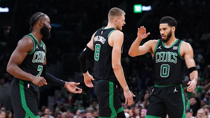 Nov 13, 2023; Boston, Massachusetts, USA; Boston Celtics forward Jayson Tatum (0), center Kristaps Porzingis (8) and guard Jaylen Brown (7) react after a play against th eNew York Knicks in the second quarter at TD Garden. Mandatory Credit: David Butler II-Imagn Images