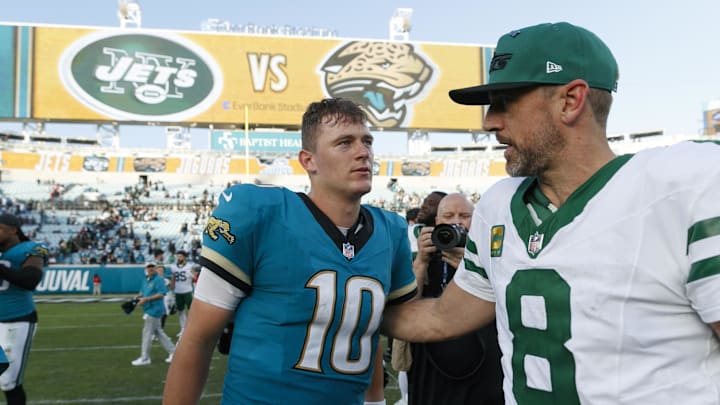 Dec 15, 2024; Jacksonville, Florida, USA; Jacksonville Jaguars quarterback Mac Jones (10) and New York Jets quarterback Aaron Rodgers (8) after the game at EverBank Stadium. Mandatory Credit: Morgan Tencza-Imagn Images