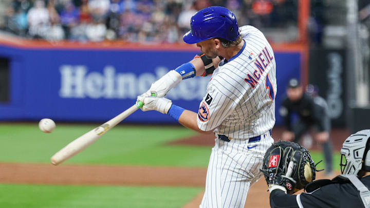 May 27, 2025; New York City, New York, USA; New York Mets second baseman Jeff McNeil (1) hits an RBI sacrifice fly during the third inning against the Chicago White Sox at Citi Field. Mandatory Credit: Vincent Carchietta-Imagn Images