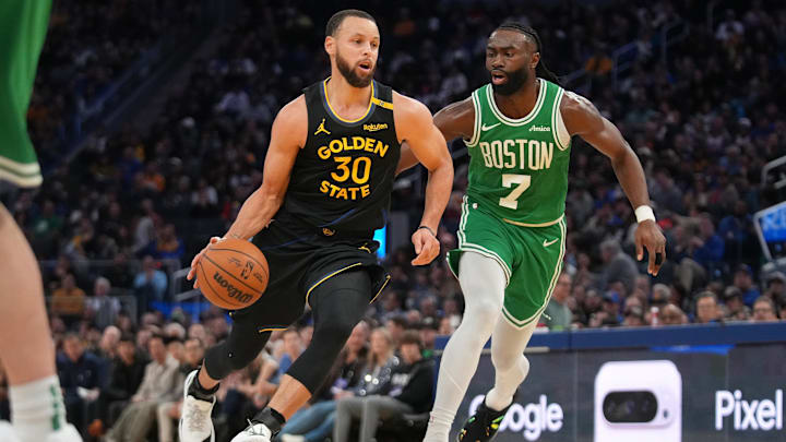 Jan 20, 2025; San Francisco, California, USA; Golden State Warriors guard Stephen Curry (30) dribbles past Boston Celtics forward Jaylen Brown (7) in the third quarter at the Chase Center. Mandatory Credit: Cary Edmondson-Imagn Images