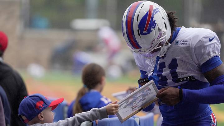 A young 6-year-old Buffalo Bills fan gets an autograph from Bills' rookie defensive back Kani Walker before training camp practice starts at St. John Fisher University in Pittsford, New York, on Aug. 13 2026. A young 6-year-old Buffalo Bills fan gets an autograph from Bills' rookie defensive back Kani Walker before training camp practice starts at St. John Fisher University in Pittsford, New York, on Aug. 13 2026.