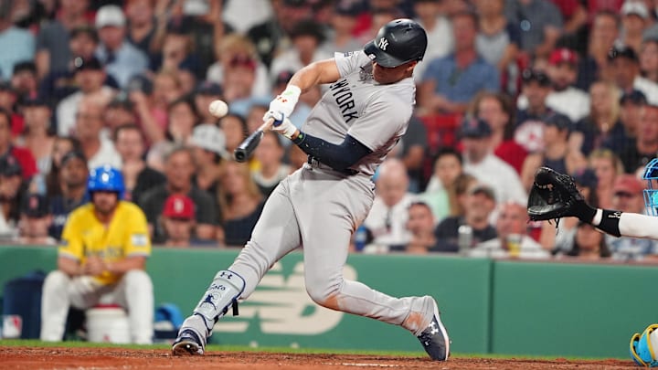 Jul 27, 2024; Boston, Massachusetts, USA; New York Yankees left fielder Juan Soto (22) hits a single against the Boston Red Sox during the tenth inning at Fenway Park. Mandatory Credit: Gregory Fisher-Imagn Images