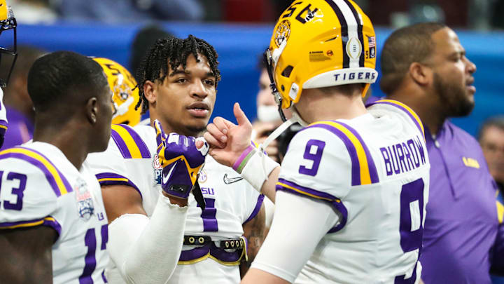 Dec 28, 2019; Atlanta, Georgia, USA; LSU Tigers wide receiver Ja'Marr Chase (1) greets quarterback Joe Burrow (9) before the 2019 Peach Bowl college football playoff semifinal game between the LSU Tigers and the Oklahoma Sooners at Mercedes-Benz Stadium. Mandatory Credit: Jason Getz-Imagn Images