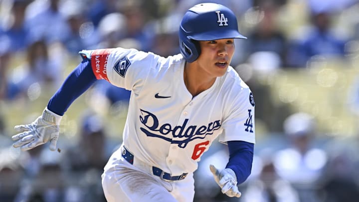 Jul 20, 2025; Los Angeles, California, USA; Los Angeles Dodgers pinch hitter Hyeseong Kim (6) runs to first base against the Milwaukee Brewers during the ninth inning at Dodger Stadium. Mandatory Credit: Jonathan Hui-Imagn Images