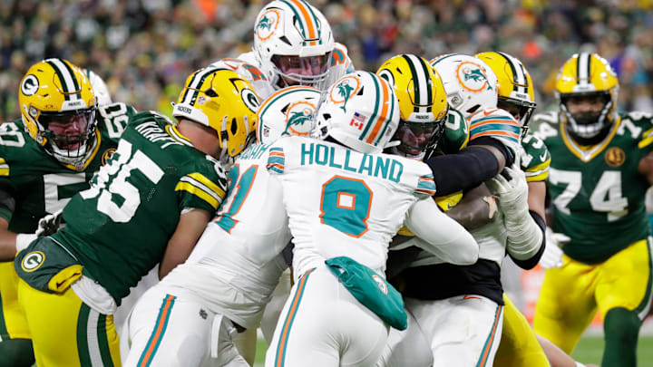 Green Bay Packers running back Josh Jacobs (8) pushes his way into the endzone for a touchdown against the Miami Dolphins.