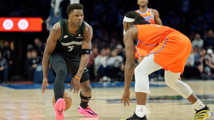 Jan 29, 2026; Minneapolis, Minnesota, USA; Minnesota Timberwolves guard Anthony Edwards (5) is defended by Oklahoma City Thunder guard Luguentz Dort (5) in the second quarter at Target Center.