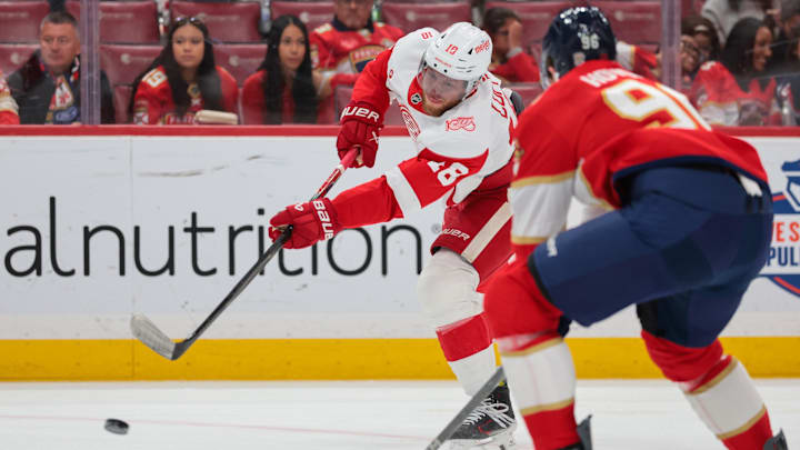Apr 15, 2026; Sunrise, Florida, USA; Detroit Red Wings center Andrew Copp (18) shoots the puck against the Florida Panthers during the first period at Amerant Bank Arena. Mandatory Credit: Sam Navarro-Imagn Images