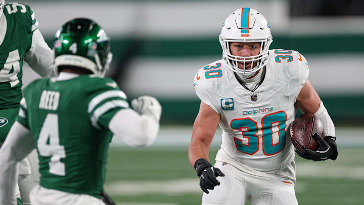 Miami Dolphins fullback Alec Ingold (30) runs with the ball during the second half as New York Jets cornerback D.J. Reed (4) pursues at MetLife Stadium. 