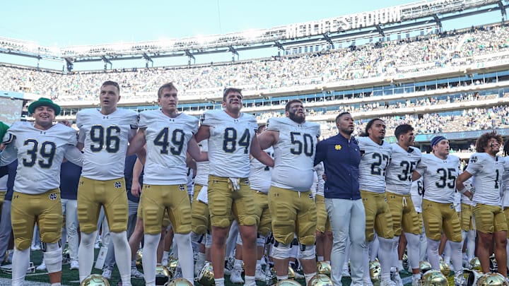 Oct 26, 2024; East Rutherford, New Jersey, USA; Notre Dame Fighting Irish head coach Marcus Freeman stands with his team for their alma mater after their game against the Navy Midshipmen at MetLife Stadium. 
