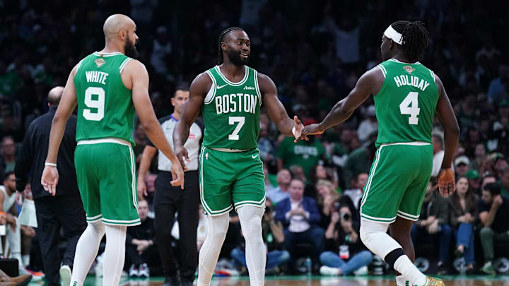 Oct 22, 2024; Boston, Massachusetts, USA; Boston Celtics guard Jaylen Brown (7), guard Jrue Holiday (4) and guard Derrick White (9) react after a play against the New York Knicks in the second half at TD Garden. Mandatory Credit: David Butler II-Imagn Images