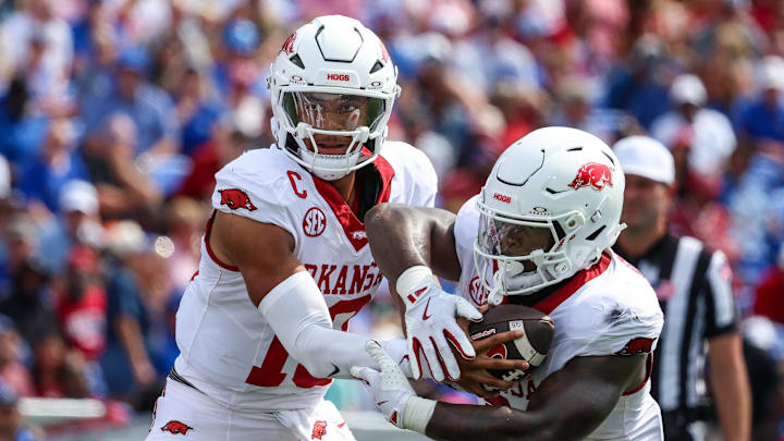 Arkansas Razorbacks quarterback Taylen Green (10) hands the ball to running back Braylen Russell (0) during the first half against the Memphis Tigers at Simmons Bank Liberty Stadium. Arkansas Razorbacks quarterback Taylen Green (10) hands the ball to running back Braylen Russell (0) during the first half against the Memphis Tigers at Simmons Bank Liberty Stadium.