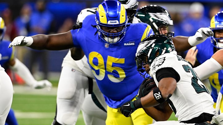 Nov 24, 2024; Inglewood, California, USA; Los Angeles Rams defensive tackle Bobby Brown III (95) tackles Philadelphia Eagles running back Saquon Barkley (26) during the first half at SoFi Stadium. Mandatory Credit: Alex Gallardo-Imagn Images Nov 24, 2024; Inglewood, California, USA; Los Angeles Rams defensive tackle Bobby Brown III (95) tackles Philadelphia Eagles running back Saquon Barkley (26) during the first half at SoFi Stadium. Mandatory Credit: Alex Gallardo-Imagn Images