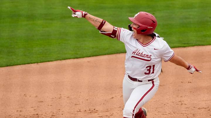 April 18, 2026; Tuscaloosa, AL, USA; Alabama batter Alexis Pupillo points to softball alumni in the left field stands as she celebrates her two-run homer in game 2 of the weekend series at Rhoads Stadium as the Crimson Tide hosted Kentucky.