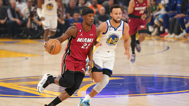 Miami Heat forward Jimmy Butler (22) dribbles past Golden State Warriors guard Stephen Curry (30) in the first quarter at the Chase Center. Mandatory Credit: Cary Edmondson-Imagn Images