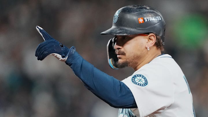 Oct 16, 2025; Seattle, Washington, USA; Seattle Mariners first baseman Josh Naylor (12) reacts after hitting a single against the Toronto Blue Jays in the fourth inning during game four of the ALCS round for the 2025 MLB playoffs at T-Mobile Park. Mandatory Credit: Stephen Brashear-Imagn Images