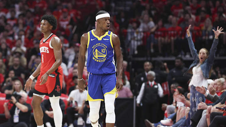 Houston Rockets forward Amen Thompson (1) and Golden State Warriors forward Jimmy Butler III (10) react after Butler scores a basket during the third quarter at Toyota Center. 