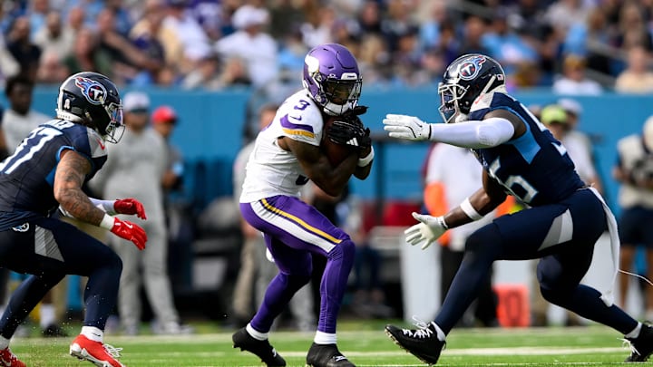 Nov 17, 2024; Nashville, Tennessee, USA;  Minnesota Vikings cornerback Stephon Gilmore (2) makes a catch between Tennessee Titans safety Amani Hooker (37) and linebacker Kenneth Murray Jr. (56) during the first half at Nissan Stadium. Mandatory Credit: Steve Roberts-Imagn Images